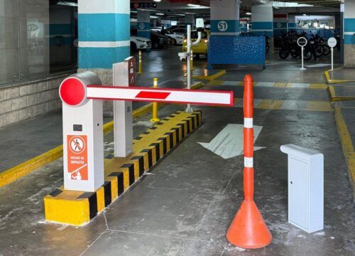 Centro Comercial Buenavista I Talanquera parqueadero separado amarillo con franjas negras bolardos amarillos con franjas blanco cartel verde aguamarina